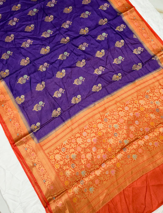 Purple and orange saree with intricate patterns on a white background
